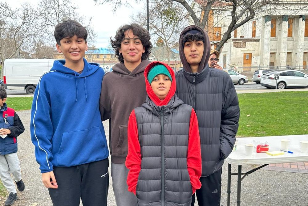 Four teenage volunteers at St. James Park before the service